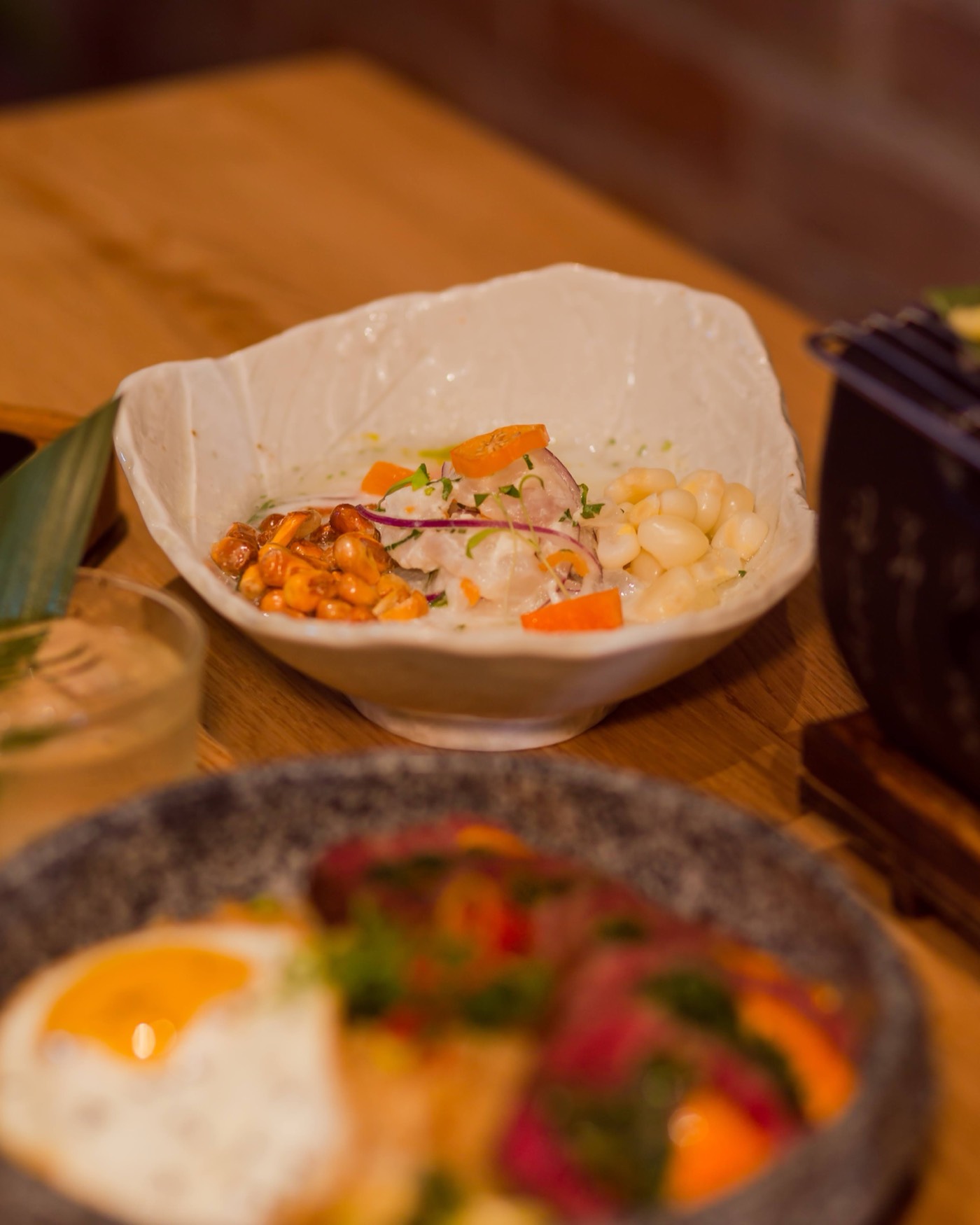 Classic Peruvian ceviche with toasted cancha and choclo in a white bowl